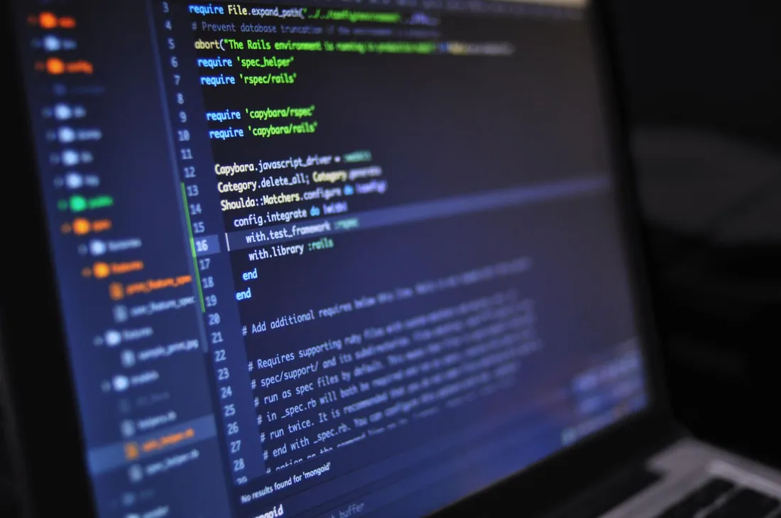 Laptop screen showing syntax-highlighted code in a dark-themed editor