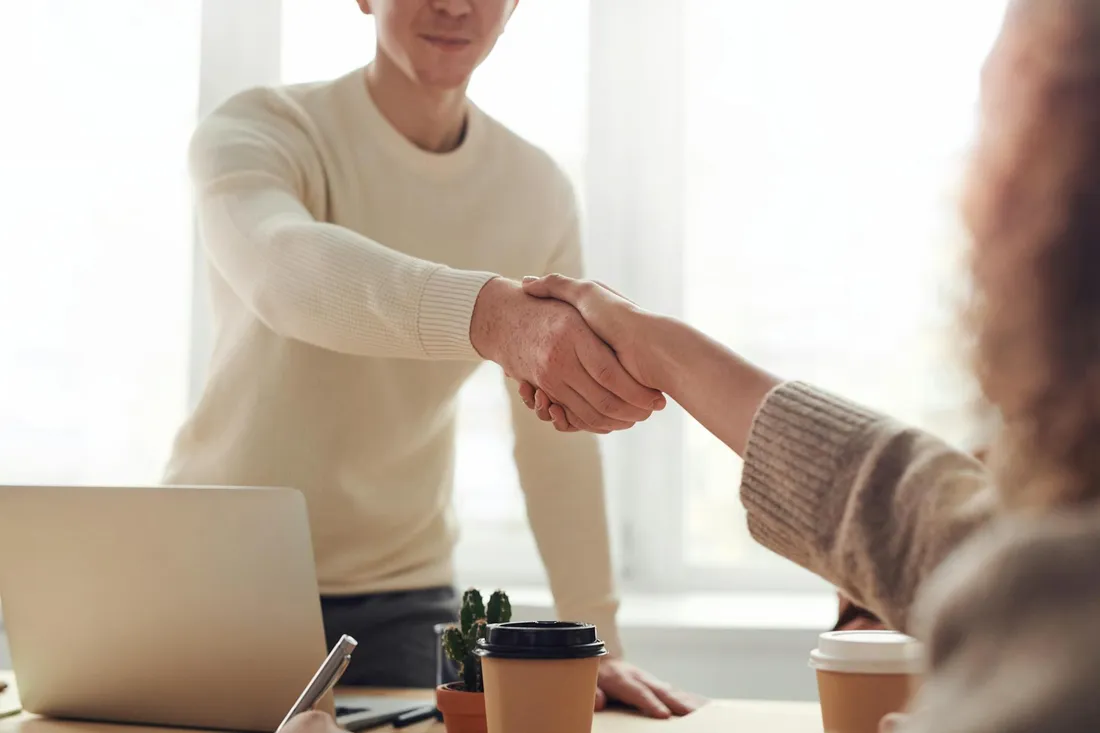 Canvider vs other ATS comparison hub — two professionals shaking hands in an office