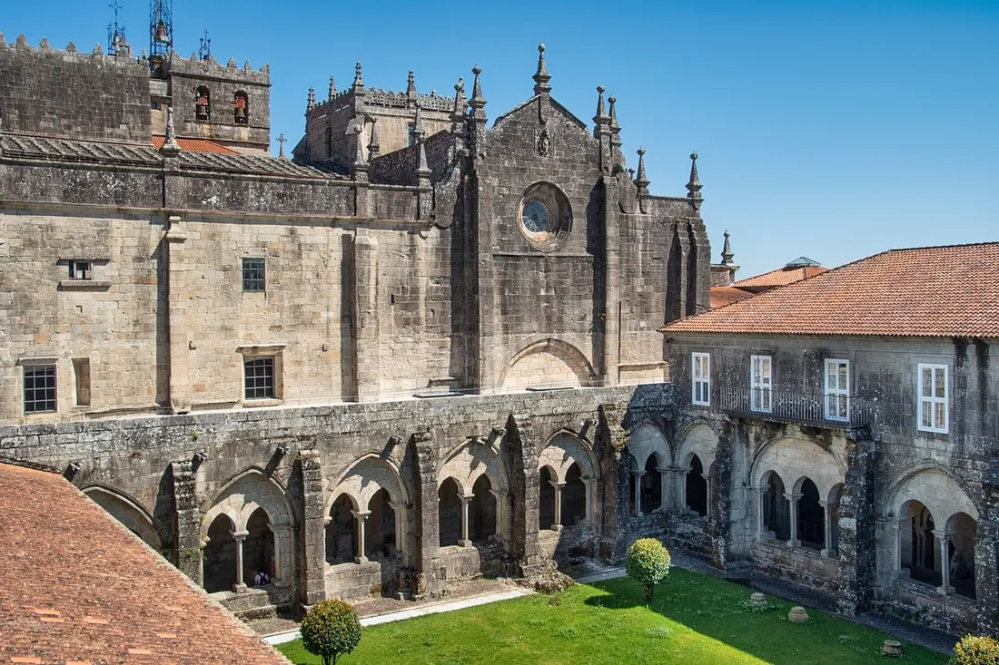 Stone church cloister arches in warm daylight