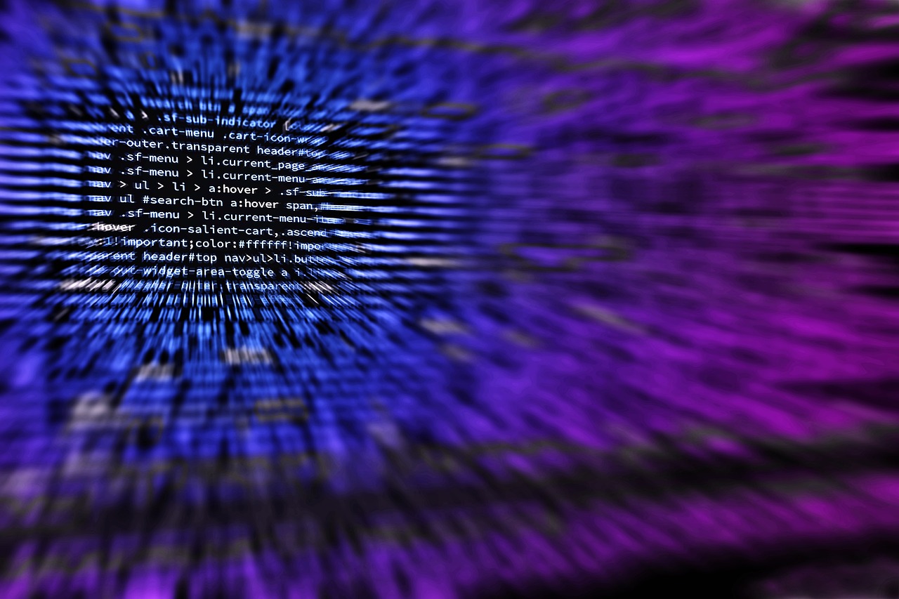 Laptop screen filled with colorful source code in a dark editor